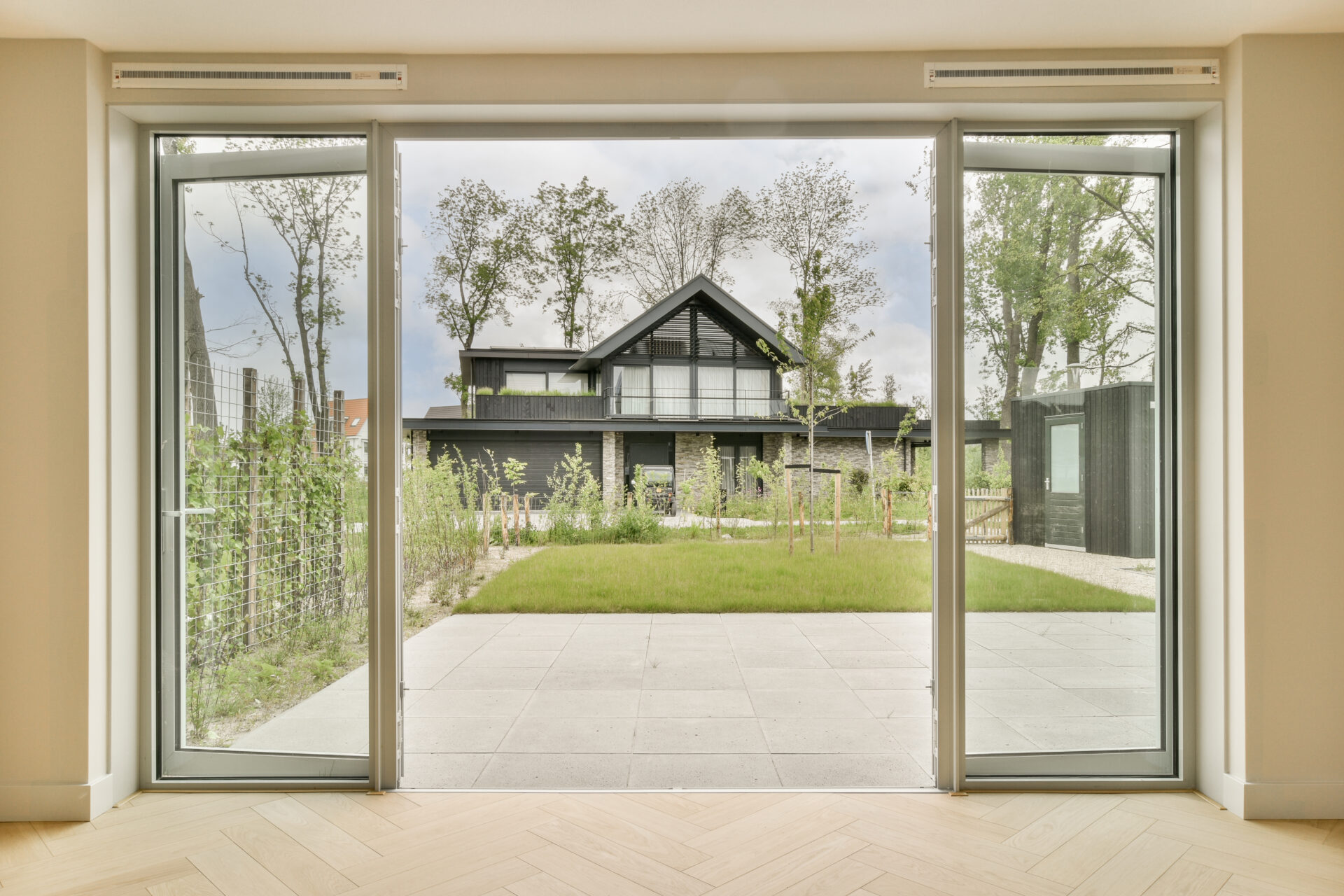 a home with a large glass door and a yard